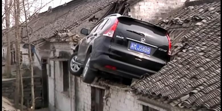 Salah Injak Pedal Gas, Mobil Sangkut di Atap Rumah Warga